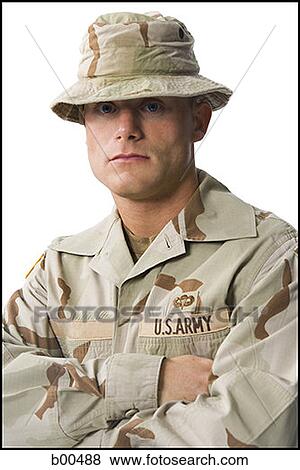 Stock Photo - Portrait of a soldier standing with his arms folded. Fotosearch