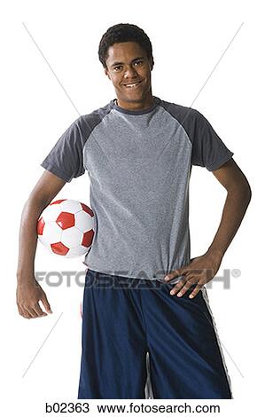 Portrait of a teenage boy with a football under his arm View Large Photo Image Stock Image - Portrait of a teenage boy with a football under his arm. Fotosearch