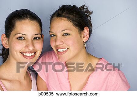 Portrait of a teenage girl and a young woman smiling View Large Photo Image Stock Photography - Portrait of a teenage girl and a young woman smiling. Fotosearch
