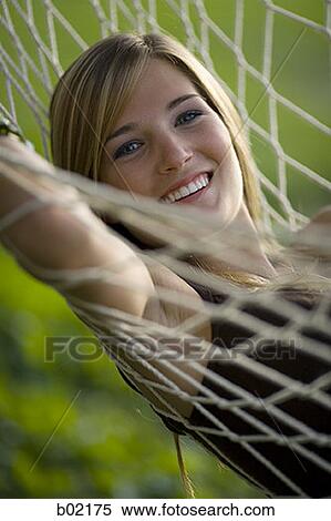 Portrait of a teenage girl resting on a hammock View Large Photo Image Stock Photography - Portrait of a teenage girl resting on a hammock. Fotosearch