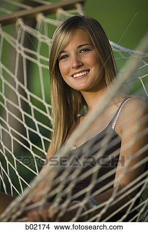 Portrait of a teenage girl sitting on a hammock View Large Photo Image Picture - Portrait of a teenage girl sitting on a hammock. Fotosearch