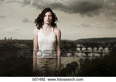 Stock Image - Portrait of a teenage girl standing in front of landscape. Fotosearch
