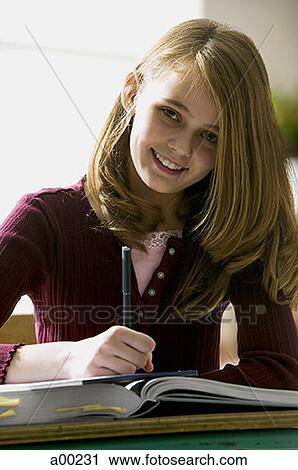 Portrait of a teenage girl writing in a book View Large Photo Image Stock Image - Portrait of a teenage girl writing in a book. Fotosearch