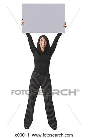 Portrait of a woman lifting up a blank sign View Large Photo Image Stock Image - Portrait of a woman lifting up a blank sign. Fotosearch