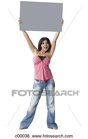Portrait of a woman lifting up a blank sign View Large Photo Image Stock Photo - Portrait of a woman lifting up a blank sign. Fotosearch