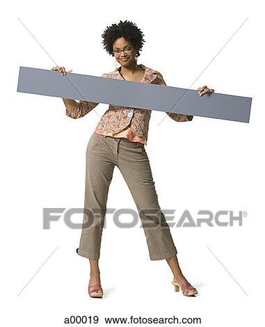 Portrait of a young African-American woman holding a blank sign View Large Photo Image Stock Photo - Portrait of a young African-American woman holding a blank sign. Fotosearch