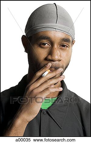 Stock Photography - Portrait of a young African-American man smoking a cigarette. Fotosearch