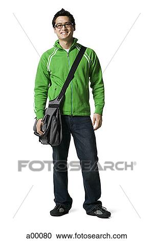 Stock Image - Portrait of a young Asian man carrying a messenger bag. Fotosearch