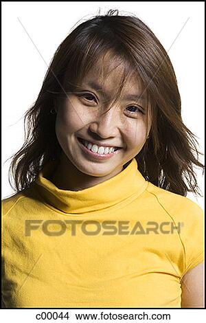 Portrait of a young Asian woman smiling View Large Photo Image Picture - Portrait of a young Asian woman smiling. Fotosearch