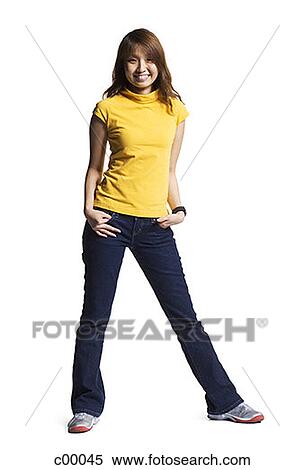 Portrait of a young Asian woman standing with hands in her pockets View Large Photo Image Stock Photography - Portrait of a young Asian woman standing with hands in her pockets. Fotosearch