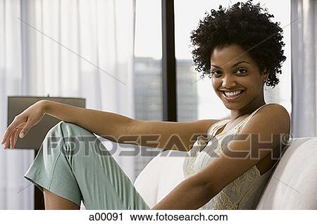 Portrait of a young Black woman smiling View Large Photo Image Stock Image - Portrait of a young Black woman smiling. Fotosearch