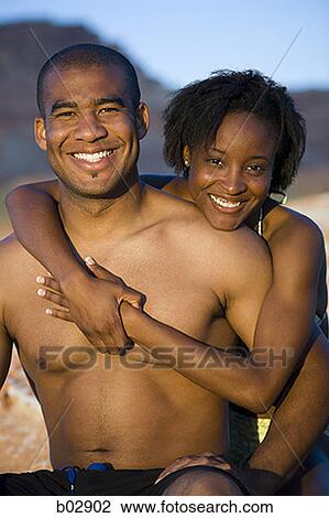 Portrait of a young couple hugging View Large Photo Image Stock Image - Portrait of a young couple hugging. Fotosearch