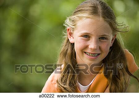 Portrait of a young girl smiling View Large Photo Image Stock Image - Portrait of a young girl smiling. Fotosearch