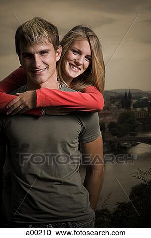 Portrait of a young man carrying a young woman piggyback View Large Photo Image Stock Image - Portrait of a young man carrying a young woman piggyback. Fotosearch