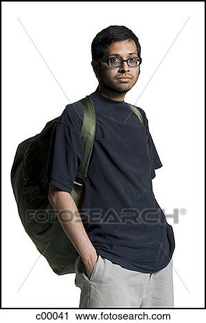 Portrait of a young man carrying a backpack with his hands in his pockets View Large Photo Image Stock Image - Portrait of a young man carrying a backpack with his hands in his pockets. Fotosearch