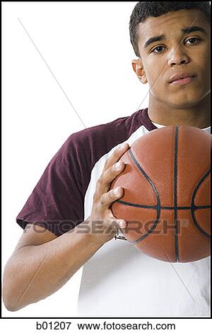 Portrait of a young man holding a ball View Large Photo Image Stock Photo - Portrait of a young man holding a ball. Fotosearch