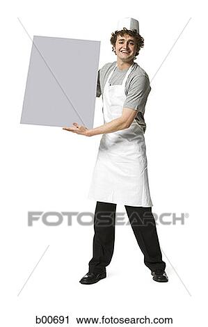 Portrait of a young man holding a blank placard View Large Photo Image Stock Image - Portrait of a young man holding a blank placard. Fotosearch