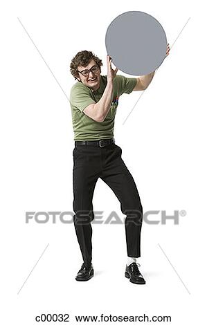 Portrait of a young man holding a blank sign and smiling View Large Photo Image Stock Image - Portrait of a young man holding a blank sign and smiling. Fotosearch