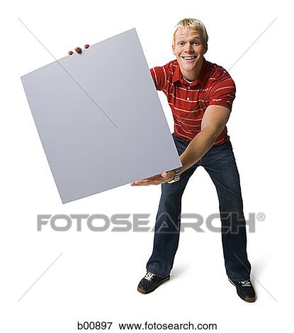 Portrait of a young man holding a blank sign View Large Photo Image Stock Photo - Portrait of a young man holding a blank sign. Fotosearch