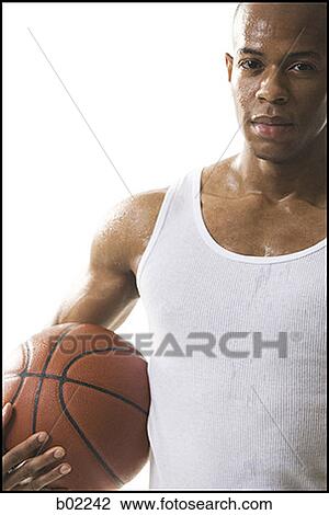 Portrait of a young man holding a basketball View Large Photo Image Stock Image - Portrait of a young man holding a basketball. Fotosearch