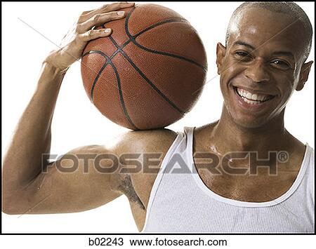 Portrait of a young man holding a basketball View Large Photo Image Stock Image - Portrait of a young man holding a basketball. Fotosearch
