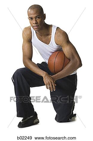 Portrait of a young man holding a basketball View Large Photo Image Stock Photo - Portrait of a young man holding a basketball. Fotosearch