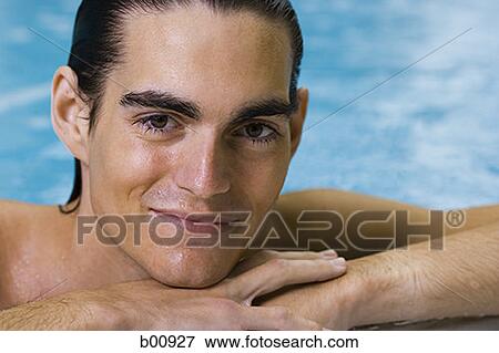 Portrait of a young man in a swimming pool View Large Photo Image Stock Photo - Portrait of a young man in a swimming pool. Fotosearch