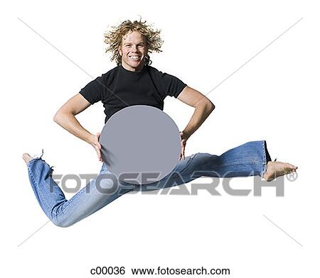 Portrait of a young man jumping and holding a blank sign View Large Photo Image Stock Photograph - Portrait of a young man jumping and holding a blank sign. Fotosearch