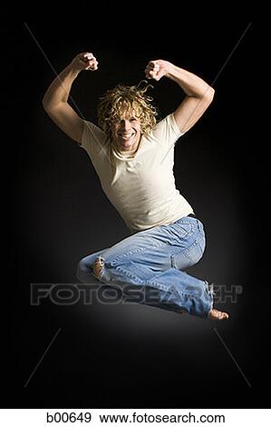 Portrait of a young man jumping View Large Photo Image Stock Photo - Portrait of a young man jumping. Fotosearch
