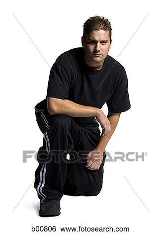 Portrait of a young man kneeling View Large Photo Image Stock Photograph - Portrait of a young man kneeling. Fotosearch