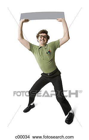 Picture - Portrait of a young man lifting up a blank sign. Fotosearch