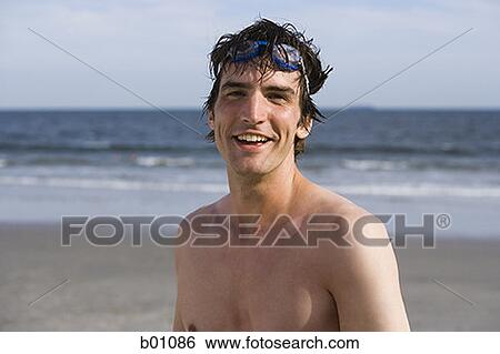 Stock Photograph - Portrait of a young man on the beach. Fotosearch