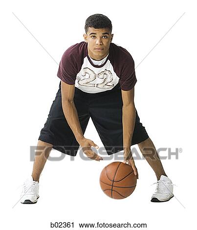 Portrait of a young man playing a basketball View Large Photo Image Stock Image - Portrait of a young man playing a basketball. Fotosearch