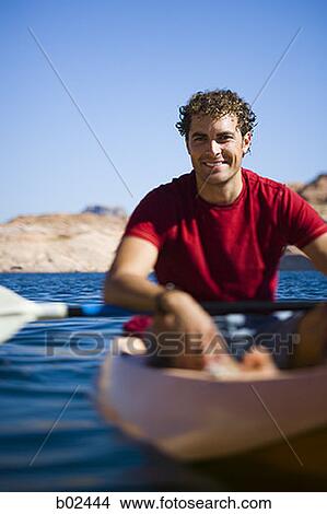 Portrait of a young man sitting in a kayak View Large Photo Image Picture - Portrait of a young man sitting in a kayak. Fotosearch