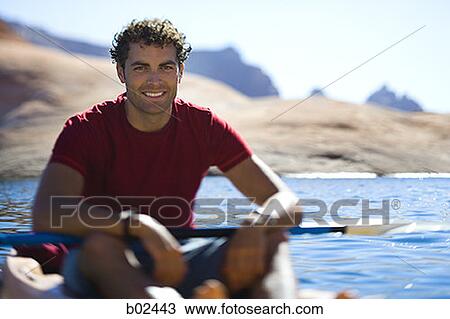 Portrait of a young man sitting in a kayak View Large Photo Image Stock Image - Portrait of a young man sitting in a kayak. Fotosearch