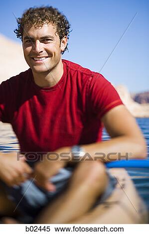 Portrait of a young man sitting in a kayak View Large Photo Image Stock Photography - Portrait of a young man sitting in a kayak. Fotosearch