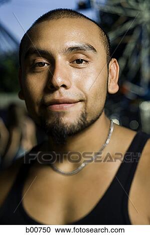 Portrait of a young man smiling in an amusement park View Large Photo Image Stock Image - Portrait of a young man smiling in an amusement park. Fotosearch