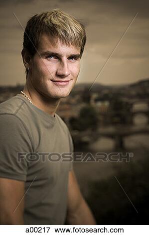 Portrait of a young man smiling View Large Photo Image Stock Photo - Portrait of a young man smiling. Fotosearch
