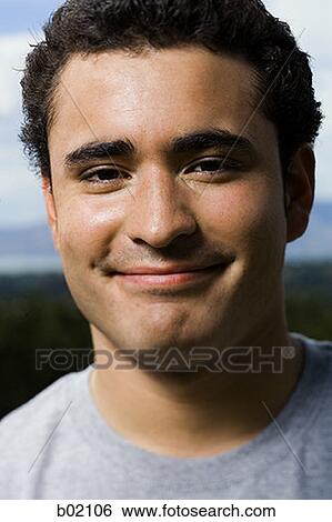Portrait of a young man smiling View Large Photo Image Stock Photograph - Portrait of a young man smiling. Fotosearch
