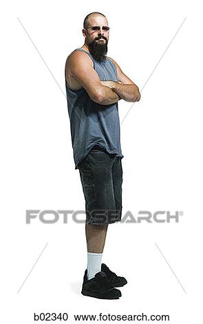 Portrait of a young man standing wearing sunglasses View Large Photo Image Stock Image - Portrait of a young man standing wearing sunglasses. Fotosearch