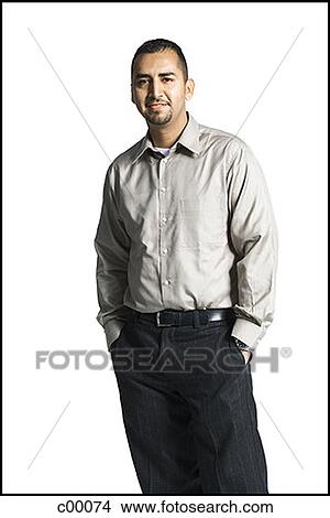 Portrait of a young man standing with hands in his pockets View Large Photo Image Picture - Portrait of a young man standing with hands in his pockets. Fotosearch