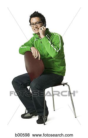 Stock Photo - Portrait of a young man talking on a mobile phone. Fotosearch