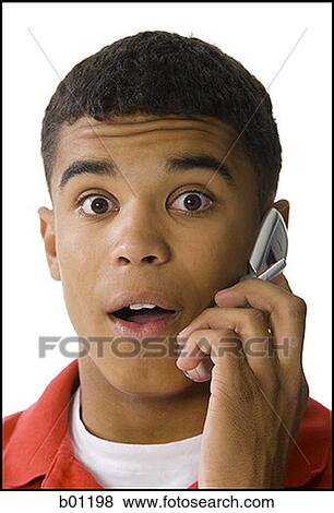 Stock Photo - Portrait of a young man talking on a mobile phone. Fotosearch