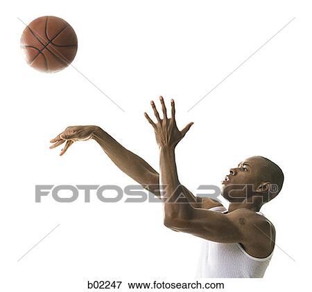 Portrait of a young man throwing a basketball View Large Photo Image Stock Photo - Portrait of a young man throwing a basketball. Fotosearch