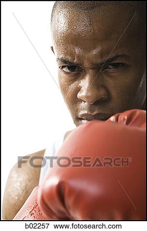 Portrait of a young man wearing boxing gloves View Large Photo Image Stock Photo - Portrait of a young man wearing boxing gloves. Fotosearch