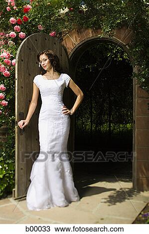 Portrait of a young modern bride standing at the doorway View Large Photo Image Stock Image - Portrait of a young modern bride standing at the doorway. Fotosearch