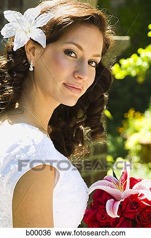 Stock Photograph - Portrait of a young modern bride wearing a flower. Fotosearch