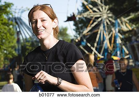 Stock Photo - Portrait of a young woman at a carnival. Fotosearch