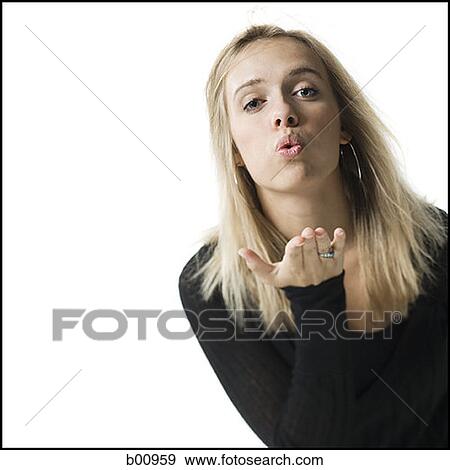 Stock Photo - Portrait of a young woman blowing a kiss. Fotosearch