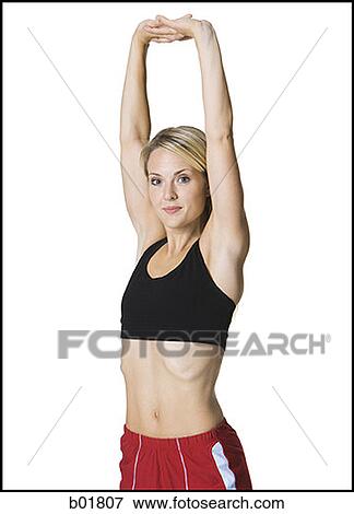 Stock Photo - Portrait of a young woman exercising. Fotosearch